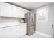 Bright kitchen with stainless steel refrigerator, white cabinets, and modern finishes at 5529 Camden Lake Pointe Nw, Acworth, GA 30101
