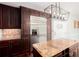 Well-designed kitchen with granite countertops, stainless steel refrigerator, island, and rich hardwood floors at 5529 Camden Lake Pointe Nw, Acworth, GA 30101