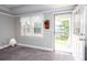 Inviting living room with scenic lake view, natural light, and cozy carpet flooring at 5529 Camden Lake Pointe Nw, Acworth, GA 30101