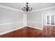 Elegant living room with hardwood floors, crown molding, and glass doors leading to another room at 5529 Camden Lake Pointe Nw, Acworth, GA 30101