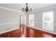 Bright, open living room with hardwood floors, crown molding, and elegant chandelier at 5529 Camden Lake Pointe Nw, Acworth, GA 30101