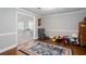 Inviting living room featuring wood-look flooring, neutral paint, and a doorway leading to a bright, open space at 5529 Camden Lake Pointe Nw, Acworth, GA 30101