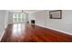 Spacious living room featuring hardwood floors, fireplace, and large windows at 5529 Camden Lake Pointe Nw, Acworth, GA 30101