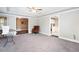 Spacious room with plush carpeting, tray ceiling, and views into the kitchen and study at 5529 Camden Lake Pointe Nw, Acworth, GA 30101