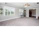 Bright living room featuring neutral walls, plush carpeting, and abundant natural light at 5529 Camden Lake Pointe Nw, Acworth, GA 30101