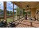 Inviting screened porch with wood floors, fan, lake views, and comfortable seating creates a relaxing outdoor space at 5529 Camden Lake Pointe Nw, Acworth, GA 30101