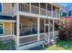 Two-story screened porch with ceiling fans and outdoor seating offers a relaxing space at 5529 Camden Lake Pointe Nw, Acworth, GA 30101