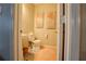 Cozy powder room featuring marble floors, pedestal sink, and artistic wall decor, providing a stylish and functional space at 7130 Oakley Ct, Union City, GA 30291