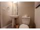 Practical half-bathroom featuring pedestal sink, toilet, and neutral tones, perfect for guests and everyday convenience at 7130 Oakley Ct, Union City, GA 30291