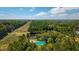 Expansive aerial view of land with lush greenery and a serene pond, creating a private oasis at 9180 Shiloh Dr, Villa Rica, GA 30180