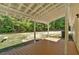 Enjoy outdoor living on this covered back porch overlooking a lush backyard, perfect for relaxation and entertaining at 9180 Shiloh Dr, Villa Rica, GA 30180