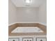 A luxurious, tiled whirlpool bathtub awaits for you to soak and unwind after a long day at 9180 Shiloh Dr, Villa Rica, GA 30180