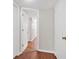 Bright hallway boasts multiple doors and wood-look flooring, offering access to various rooms within the home at 9180 Shiloh Dr, Villa Rica, GA 30180