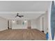 Open-concept living room with modern ceiling fan, archways, and new floors at 9180 Shiloh Dr, Villa Rica, GA 30180