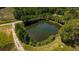 Scenic view of a tranquil pond bordered by lush greenery and a clear blue sky at 9180 Shiloh Dr, Villa Rica, GA 30180