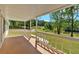 Spacious covered porch showcases a scenic view of a lush yard and serene lake at 9180 Shiloh Dr, Villa Rica, GA 30180