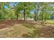 Large, open yard with mature trees providing shade for a relaxing, natural setting at 9180 Shiloh Dr, Villa Rica, GA 30180