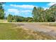 Expansive yard surrounded by mature trees, offering privacy and space for outdoor activities at 9180 Shiloh Dr, Villa Rica, GA 30180