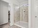 Bathroom featuring glass shower and doorway to large closet with built-in shelving at 114 Green Tree Ct, Dacula, GA 30019