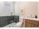 Modern bathroom featuring a glass-enclosed shower with contrasting tile and stylish vanity at 1453 Hartford Sw Ave, Atlanta, GA 30310