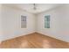 Bright and airy bedroom with hardwood floors, two windows and a ceiling fan at 1453 Hartford Sw Ave, Atlanta, GA 30310
