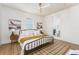 Cozy bedroom featuring a wrought iron bed frame, neutral decor, and a view into the bathroom at 1453 Hartford Sw Ave, Atlanta, GA 30310