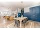 Open dining room featuring a wood table set, modern chandelier and access to the kitchen at 1453 Hartford Sw Ave, Atlanta, GA 30310