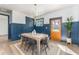 Dining room with wood table, stylish decor, blue paneled walls, and a view of outdoors at 1453 Hartford Sw Ave, Atlanta, GA 30310