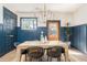 Dining room boasting modern light fixture, blue paneled walls, and stylish decor elements at 1453 Hartford Sw Ave, Atlanta, GA 30310