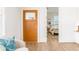 Inviting entryway featuring a wood door with glass, hardwood floors, and view into the bedroom at 1453 Hartford Sw Ave, Atlanta, GA 30310