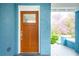 Inviting front entryway with a stylish wooden door and blue painted brick at 1453 Hartford Sw Ave, Atlanta, GA 30310