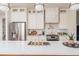 Well-lit kitchen featuring an island sink, stainless steel refrigerator, and white cabinets at 1453 Hartford Sw Ave, Atlanta, GA 30310