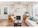 Sunlit living room with decorative fireplace, hardwood floors, and neutral décor at 1453 Hartford Sw Ave, Atlanta, GA 30310