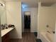 Bathroom with a vanity, tub, and doorway to a walk-in closet at 3191 Creston Park Ct, Duluth, GA 30096
