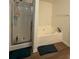 Bathroom featuring a shower and a soaking tub on wood look floors at 3191 Creston Park Ct, Duluth, GA 30096