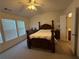 Bedroom with a decorative bed, matching dressers, and an open bathroom at 3191 Creston Park Ct, Duluth, GA 30096