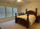 Bedroom with a decorative bed, matching dressers, three windows and neutral carpet at 3191 Creston Park Ct, Duluth, GA 30096