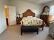 Bedroom with neutral carpet, wood furniture, and a door to the bathroom at 3191 Creston Park Ct, Duluth, GA 30096