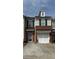 Charming townhome with brick and siding exterior, featuring a two-car garage and well-maintained lawn at 3191 Creston Park Ct, Duluth, GA 30096