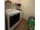Laundry room with a washer, dryer, and storage shelves at 3191 Creston Park Ct, Duluth, GA 30096
