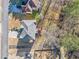 Overhead view of a home and backyard, displaying deck, driveway, and surrounding trees at 1039 Ashfern Walk, Woodstock, GA 30189
