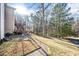 Expansive backyard with a brick pathway and wooden deck, ideal for outdoor entertaining at 1039 Ashfern Walk, Woodstock, GA 30189