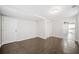 Basement room with laminate wood flooring, showing view to kitchen and closet storage at 1039 Ashfern Walk, Woodstock, GA 30189