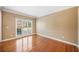 Bright bedroom featuring hardwood flooring, and large windows providing natural light at 1039 Ashfern Walk, Woodstock, GA 30189