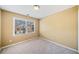 Cozy bedroom with neutral carpeting, a large window, and ample natural light at 1039 Ashfern Walk, Woodstock, GA 30189