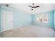 Spacious bedroom featuring neutral carpet, a ceiling fan, and large window at 1039 Ashfern Walk, Woodstock, GA 30189