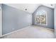 Vaulted ceiling bedroom with neutral carpet and a large arched window for ample natural light at 1039 Ashfern Walk, Woodstock, GA 30189
