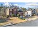 Brick front home boasts a manicured lawn and attached two-car garage at 1039 Ashfern Walk, Woodstock, GA 30189