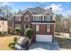 Beautiful two-story brick home with attached two-car garage at 1039 Ashfern Walk, Woodstock, GA 30189