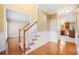 Inviting foyer showcasing hardwood floors, wainscoting, and stairway at 1039 Ashfern Walk, Woodstock, GA 30189